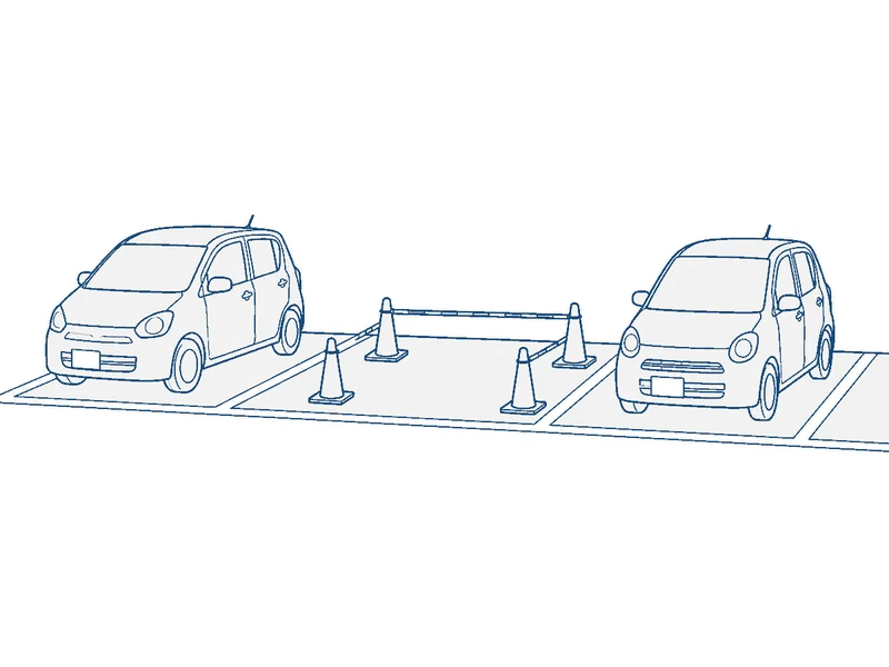 駐車場の一区画だけをコーンで閉め、ほかは通常どおり使えるようにしている図